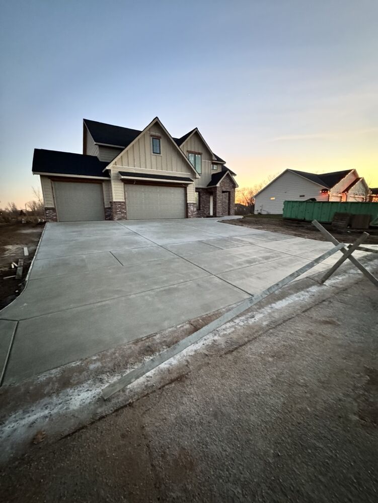 New Tallgrass custom home build, evening view of driveway and garage