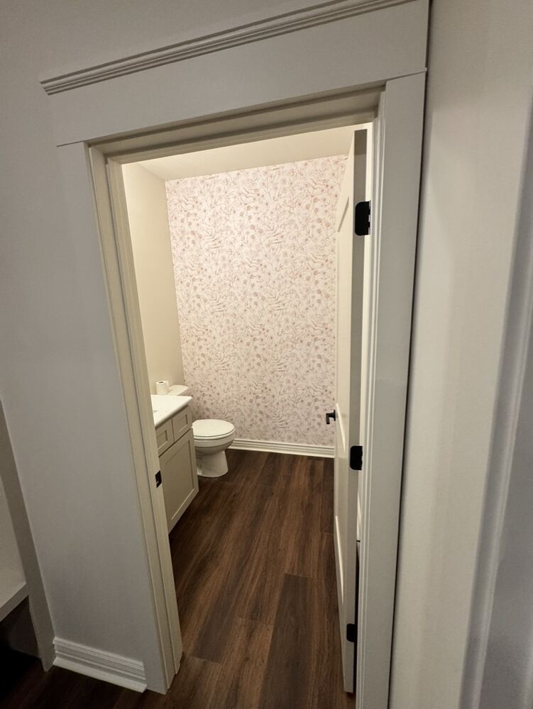 New Tallgrass build, powder room with floral wallpaper accent