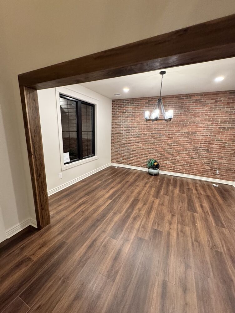 New Tallgrass build, dining room with exposed brick accent wall