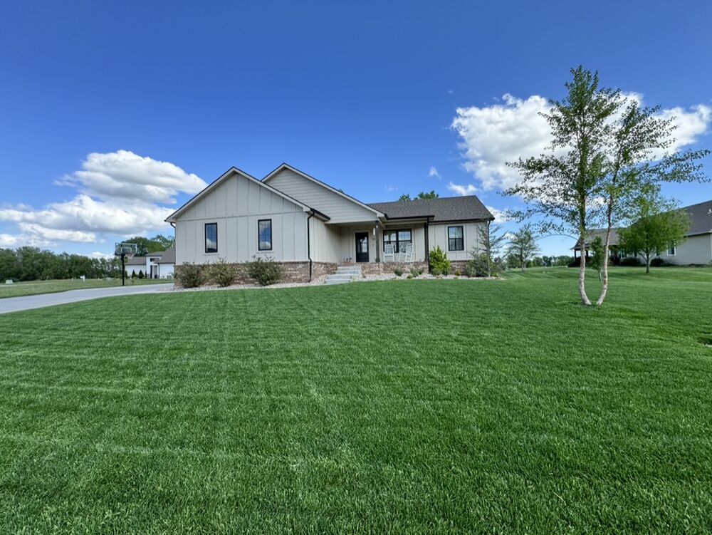 New Tallgrass custom home build, front lawn view on a sunny day