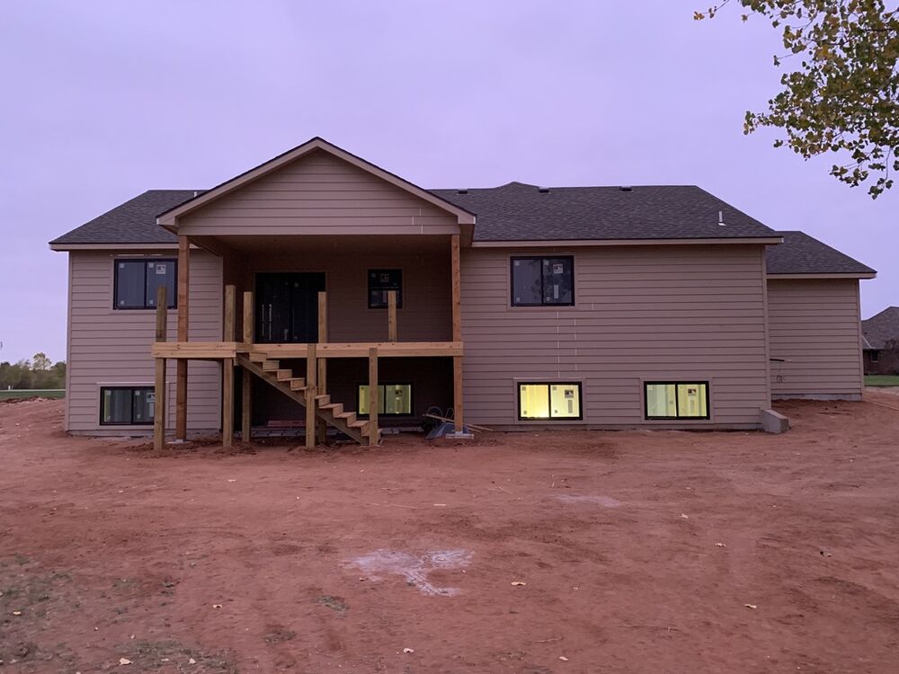 New Tallgrass build, back exterior siding installed at dusk