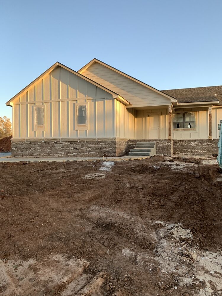 New Tallgrass build, front exterior siding installed at sunset